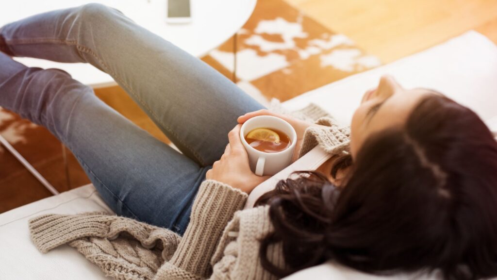 Woman eating mindfully at a table, looking relaxed