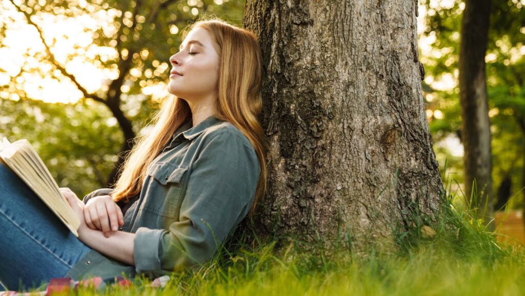Woman sitting quietly with a book, at rest